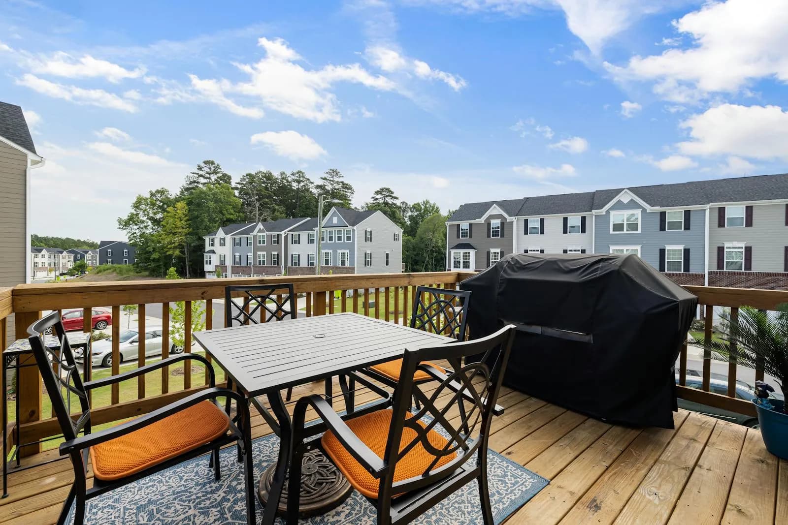 Finished backyard wood deck with seating in a suburban residential setting.