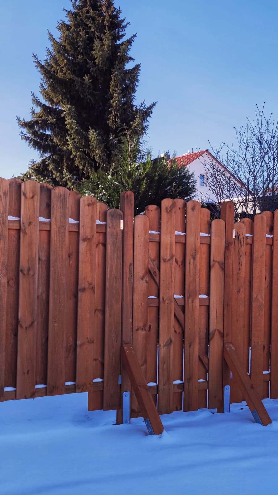 Saavedra's Construction crew member installing a new wood privacy fence