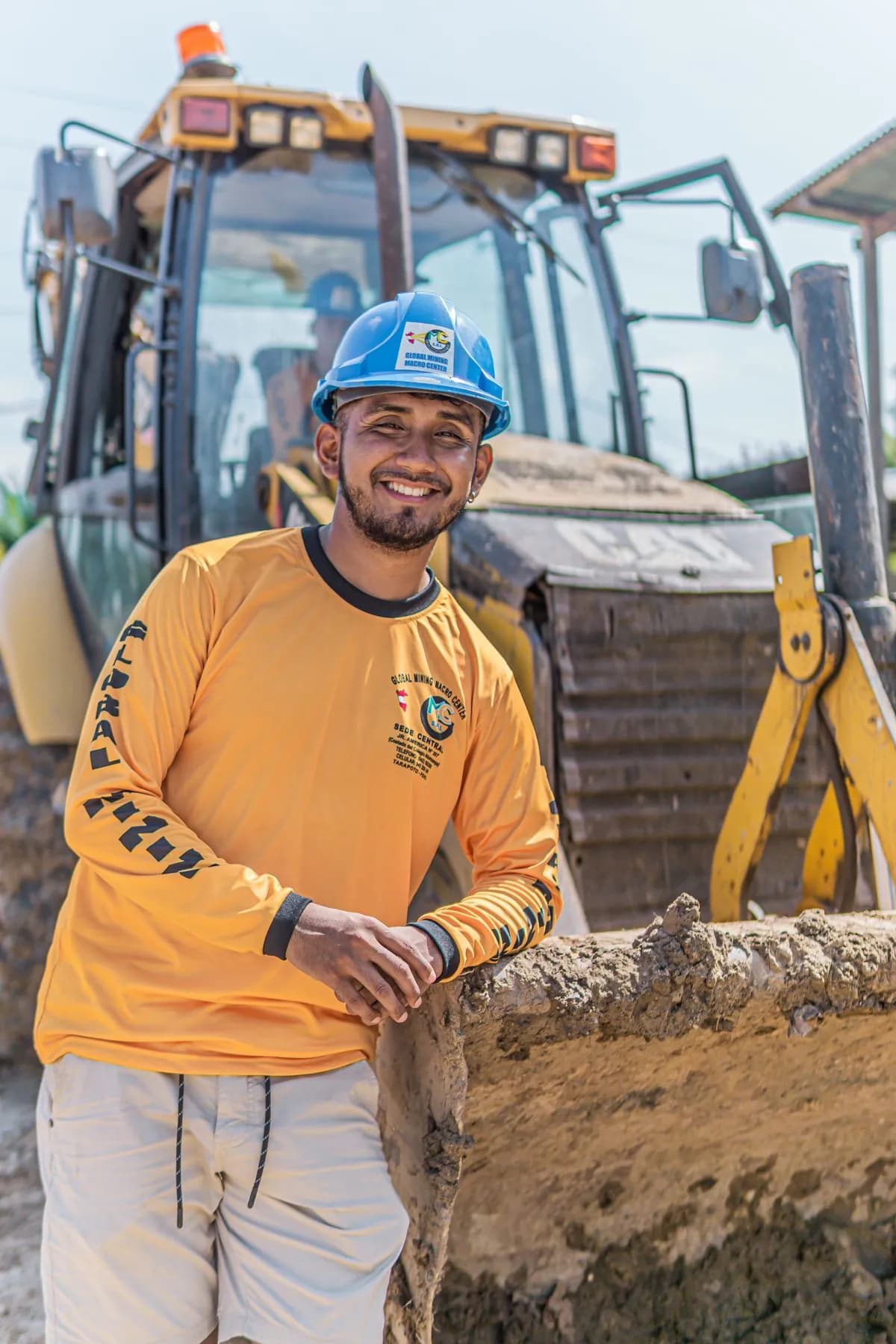 Representative owner-operator style construction worker portrait near equipment.