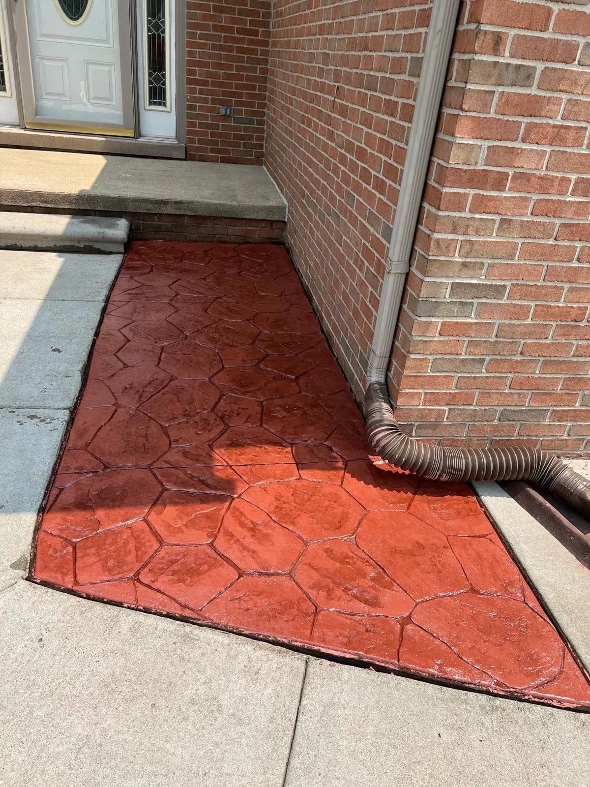 Patterned stamped concrete walkway at a residential front entry
