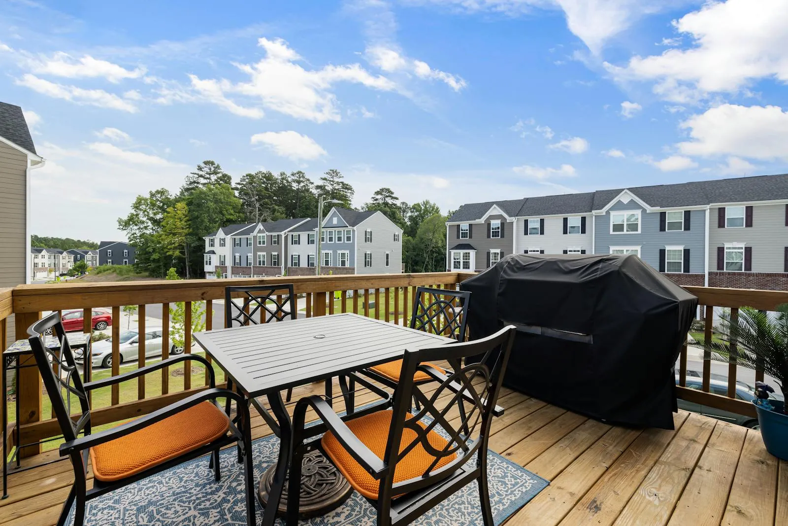 Finished backyard wood deck with seating in a suburban residential setting.